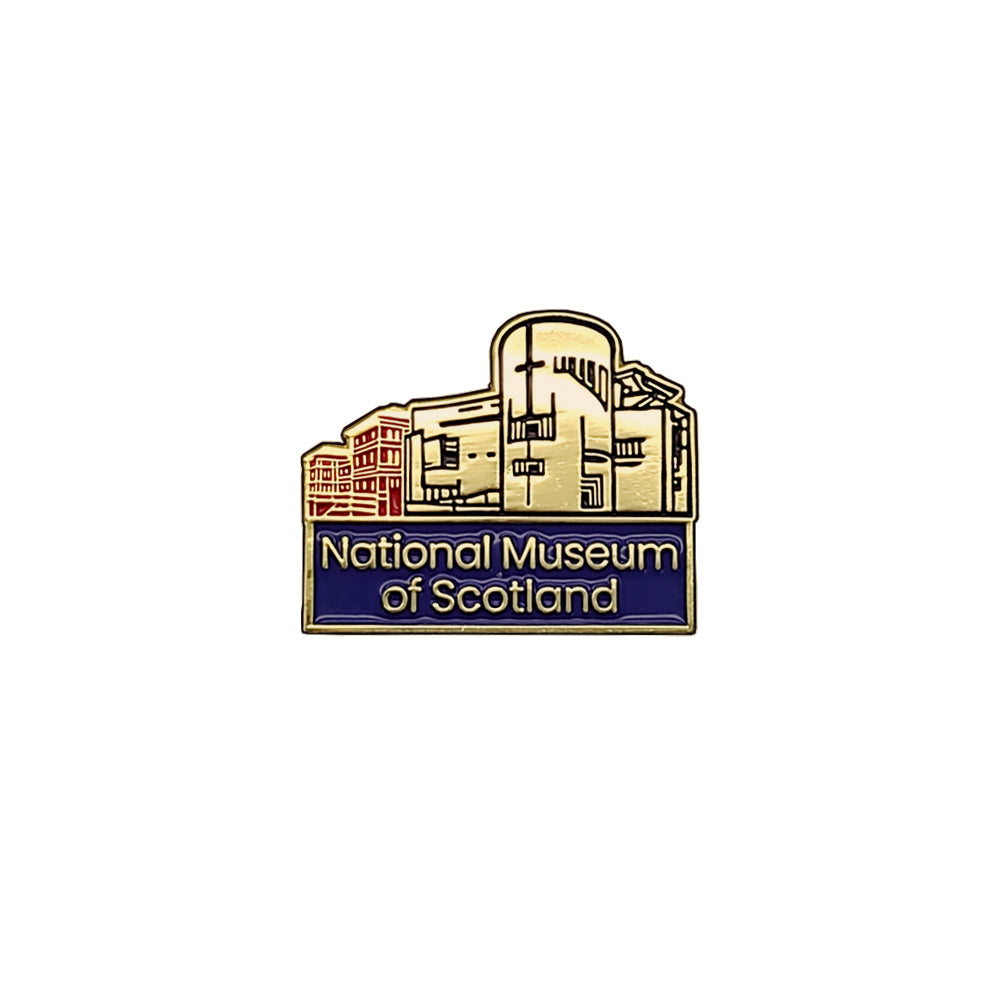 A metallic pin badge with an image of the national museum of Scotland. Beneath the image are the words 'national museum of Scotland against navy blue. The badge is against a plain white background. 
