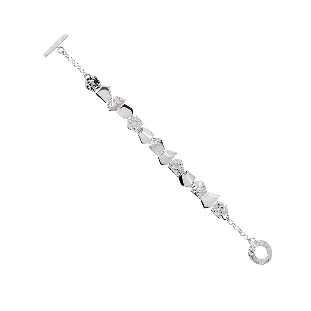 Silver bracelet with textured pentagonal detailing.