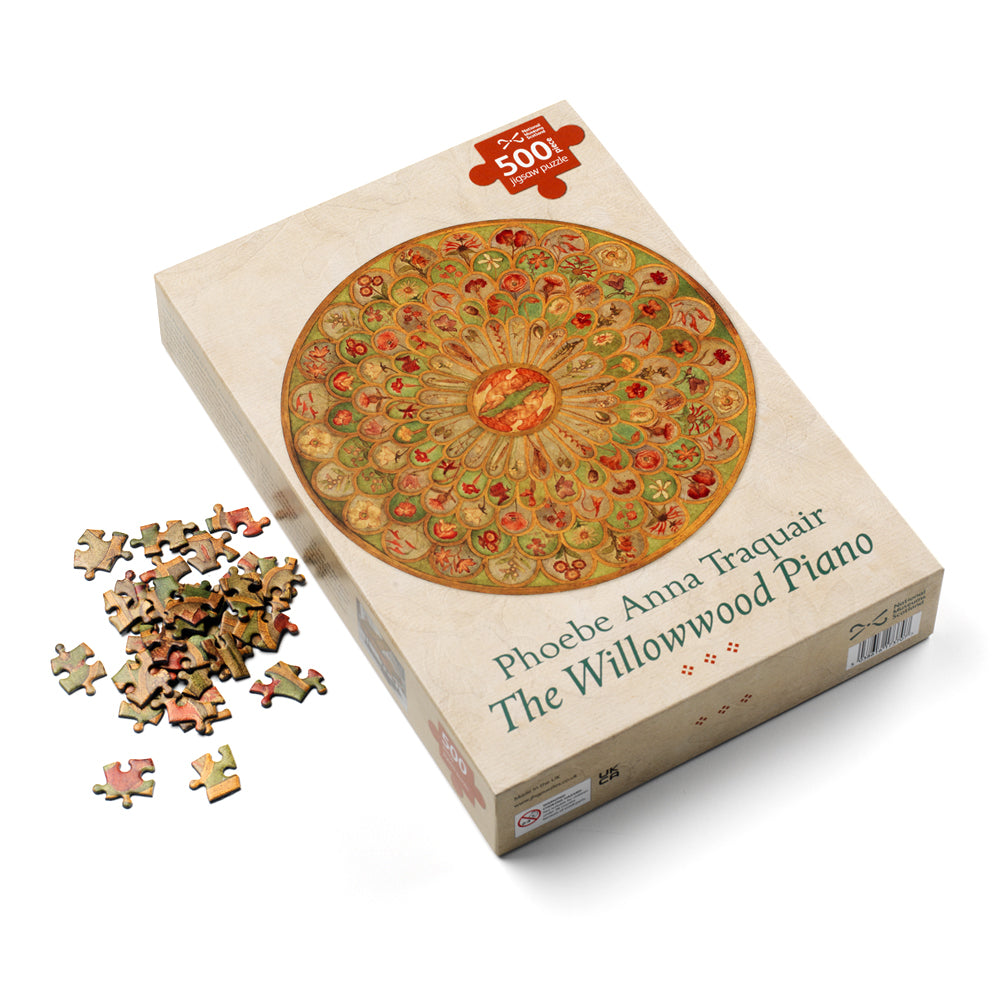 A jigsaw puzzle box with a circular design of a detail from the 'Willowwood Piano' by Phoebe Anna Traquair on the front. Beside the box is a small pile of puzzle pieces.