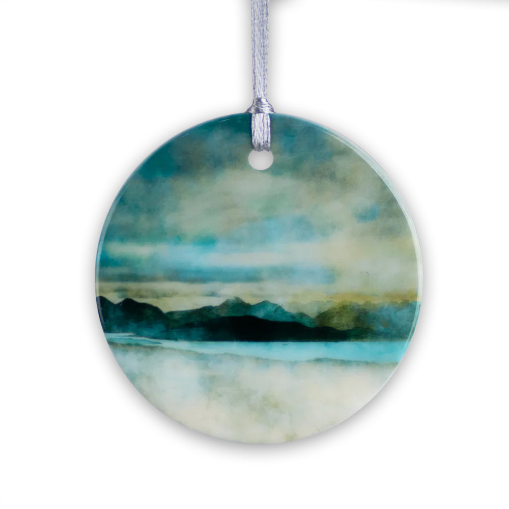 Round porcelain hanging decoration with a watercolour painting of a view of the Isle of Skye.