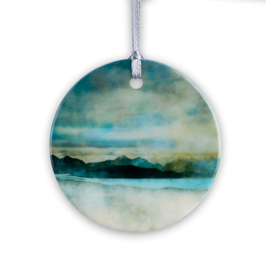 Round porcelain hanging decoration with a watercolour painting of a view of the Isle of Skye.