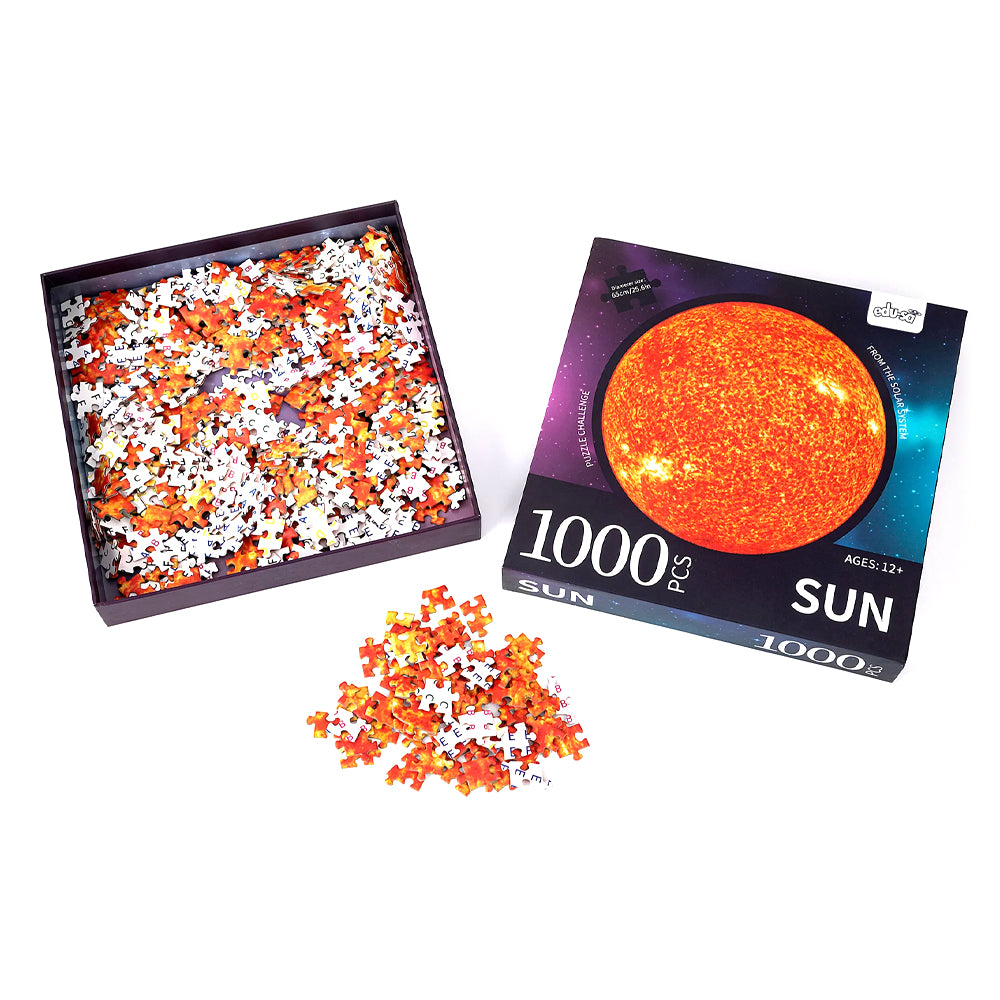 Jigsaw box opened with a selection of pieces scattered.