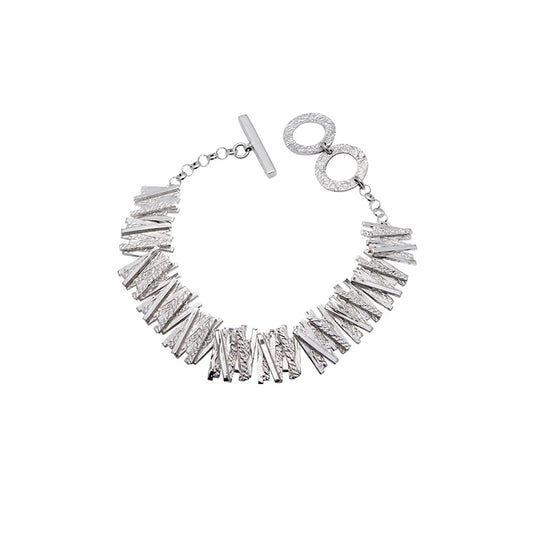 Silver bracelet with geometric overlapping line detailing.