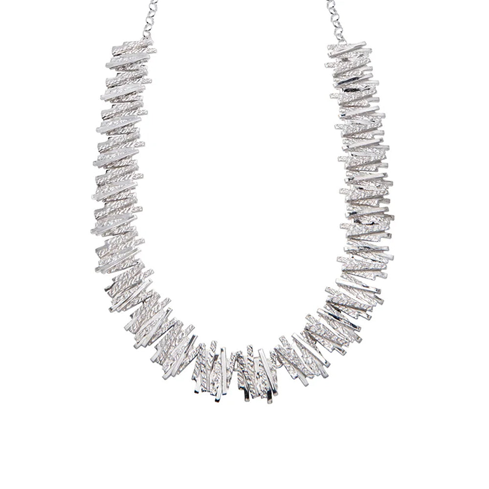 Silver necklace with geometric overlapping line detailing.