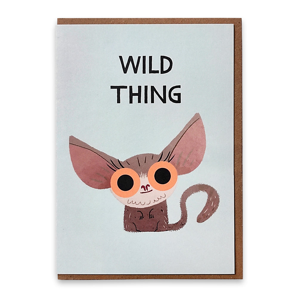 A photograph of a greetings card with an illustration of a bush baby with large orange eyes with the words "wild thing above it.