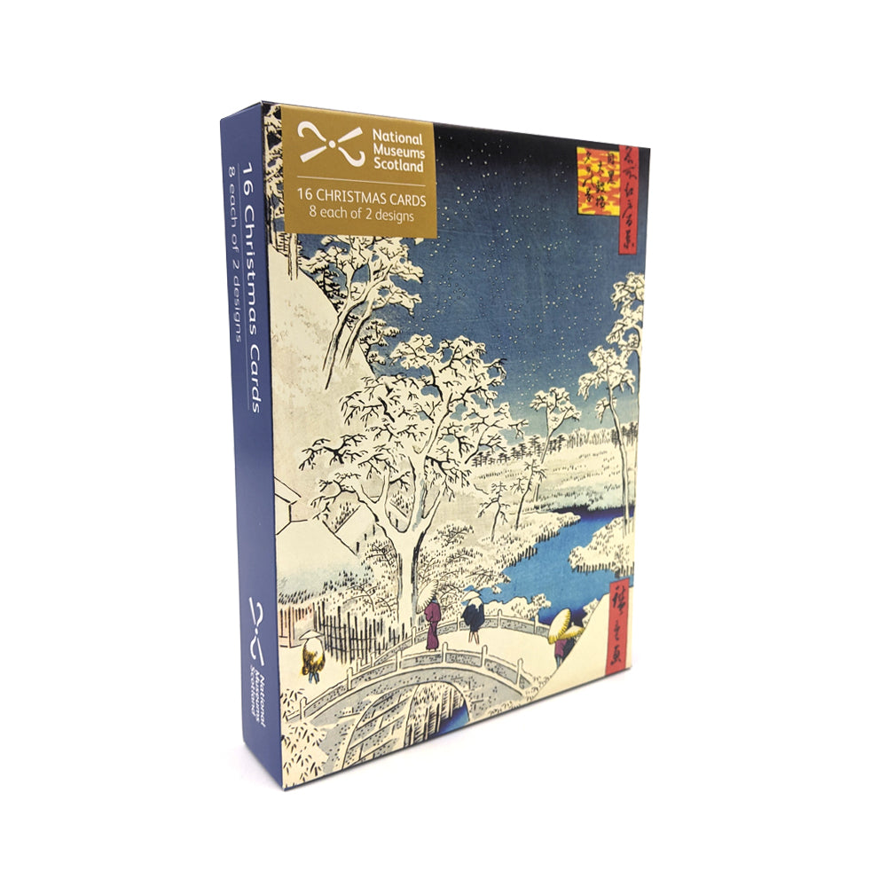 A box of Christmas cards with a Japanese woodcut print of a landscape of a bridge in a wooded snowy scene.