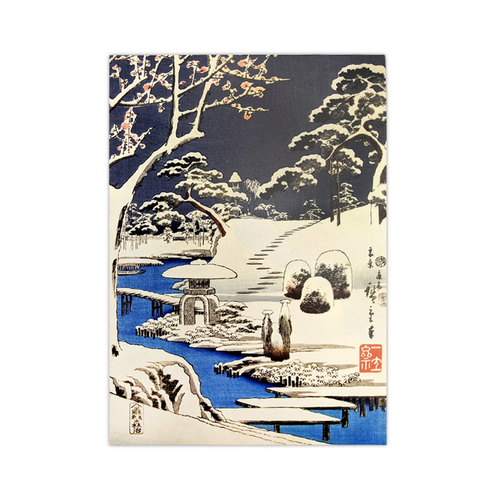 A Christmas card with a Japanese woodcut print of a snowy scene of a Japanese shrine surrounded by trees.