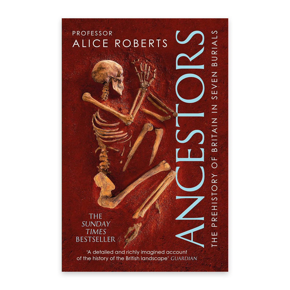 A book cover against a plain white background with a photograph of a skeleton half buried in red sand. The book title is written vertically along the pages edge. in a pale blue font.