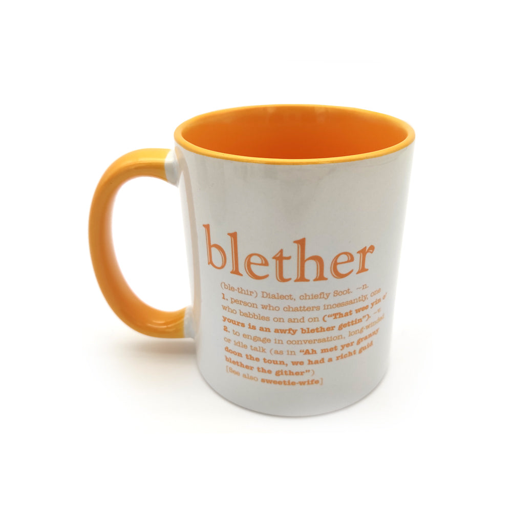 A white mug with a yellow inside and handle against a plain white background. The mug is printed with the word blether and its definition.
