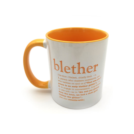 A white mug with a yellow inside and handle against a plain white background. The mug is printed with the word blether and its definition.