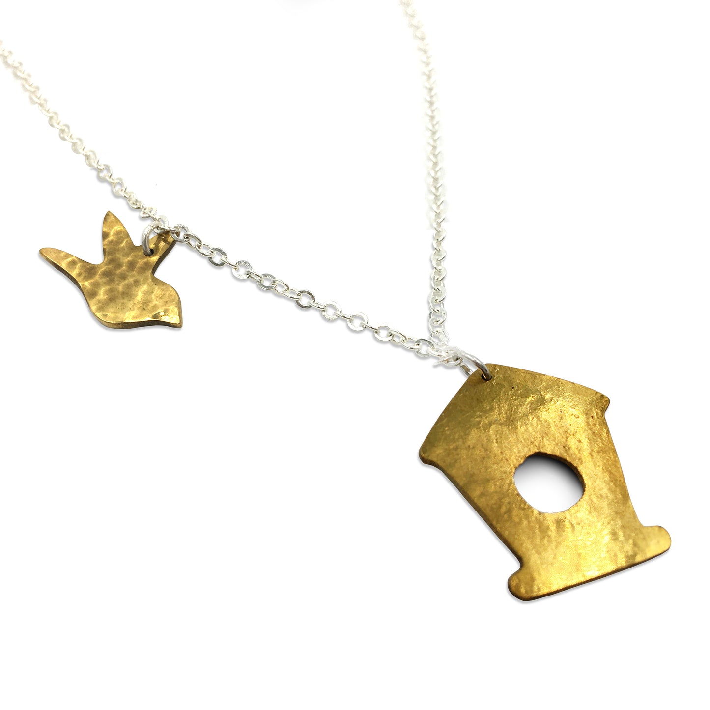 Brass chain necklace with a brass charms of a bird and a birdhouse against a plain white background.