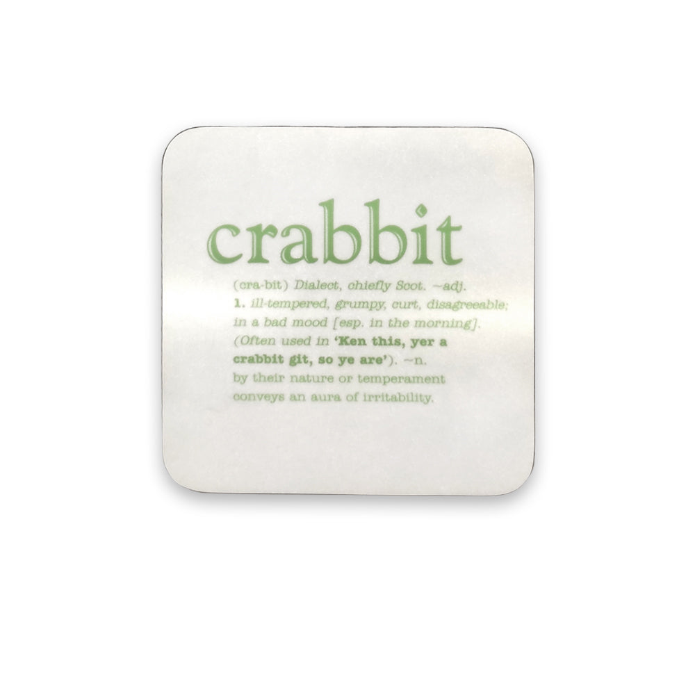 A white coaster with green text of the word crabbit and its definition against a plain white background.