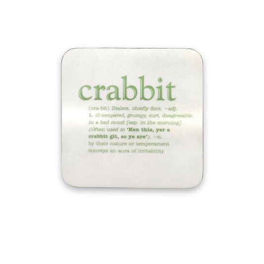 A white coaster with green text of the word crabbit and its definition against a plain white background.