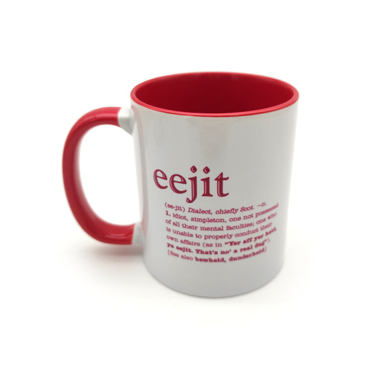 A white mug with a red inside and handle against a plain white background. The mug is printed with the word eejit and its definition.