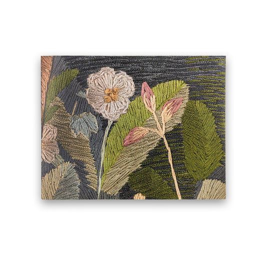 A horizontal rectangular greetings card with a detail from the 'Red Cross Knight' series of tapestries by Phoebe Anna Traquair. The detail is of a white flower and a pink flower against green leaves.