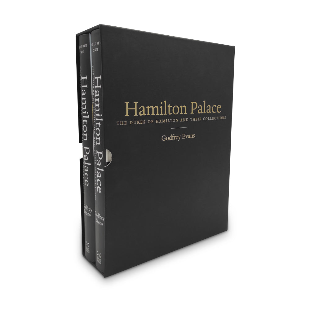 Two books with a black spine inside a black cardboard sleeve. The words 'Hamilton Palace' are down the books' spines in a white serif font and in gold on the front of the cardboard sleeve.