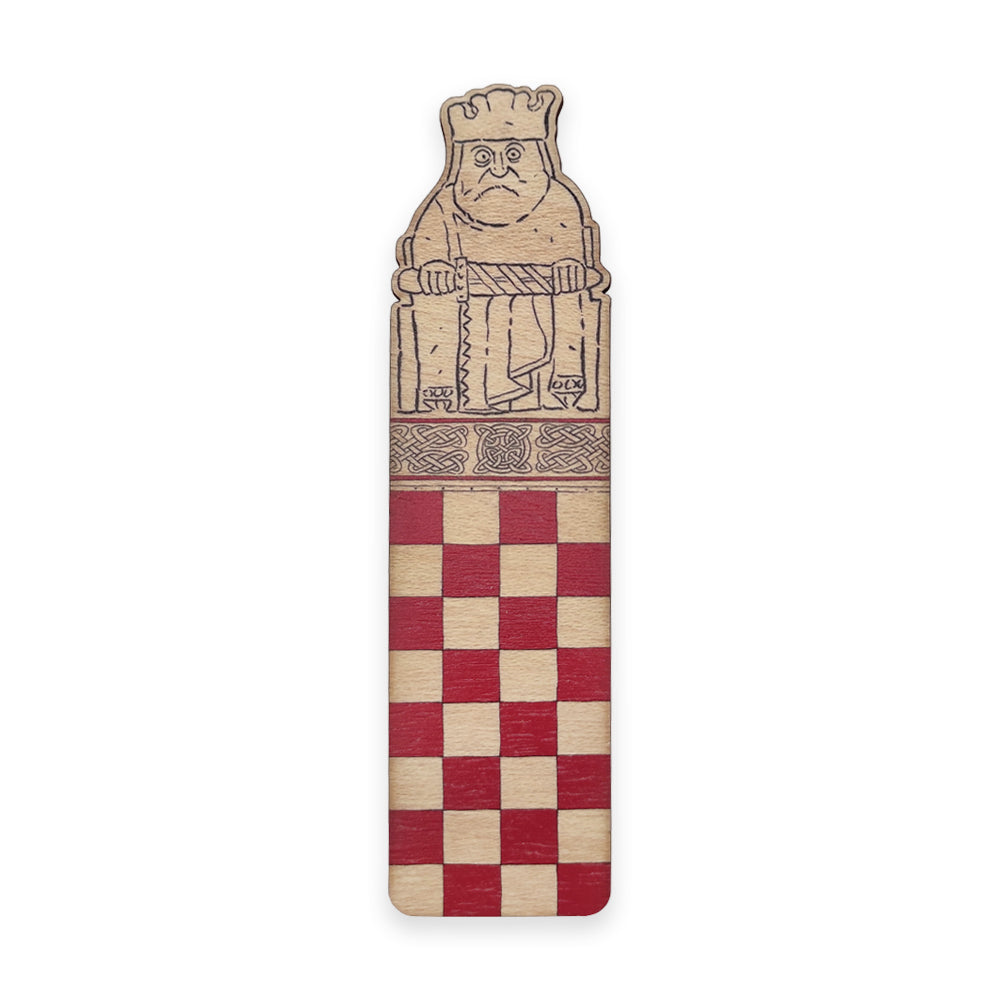 A wooden bookmark with the top half illustrated with a king Lewis chess piece and the bottom half with a red chessboard style grid.