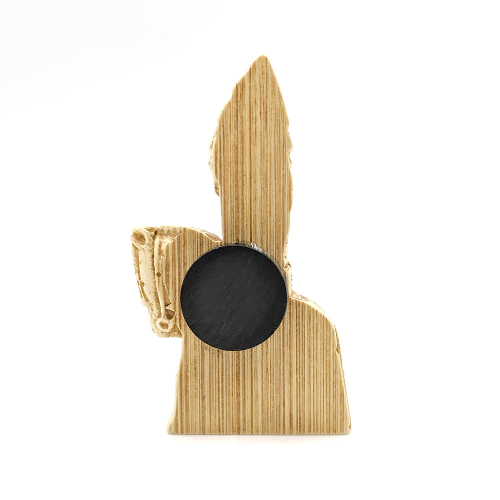 A plastic resin replica magnet of a knight Lewis chess piece. A side view with the knight cut in half with a round magnet attached to the back.