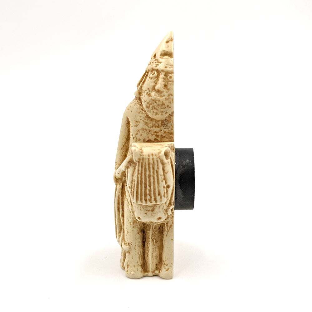 A plastic resin replica magnet of a knight Lewis chess piece. A knight on a horse, the knight is wearing a pointed hat and holding a large spear. A side view with the knight cut in half with a round magnet attached to the back.