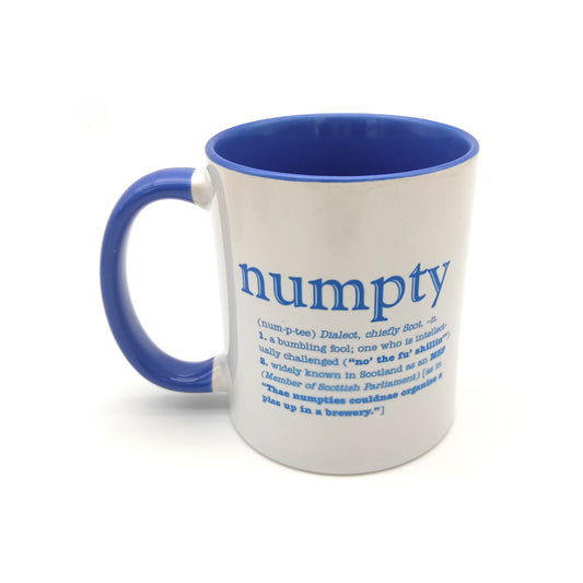 A white mug with a blue inside and handle against a plain white background. The mug is printed with the word numpty and its definition in blue.