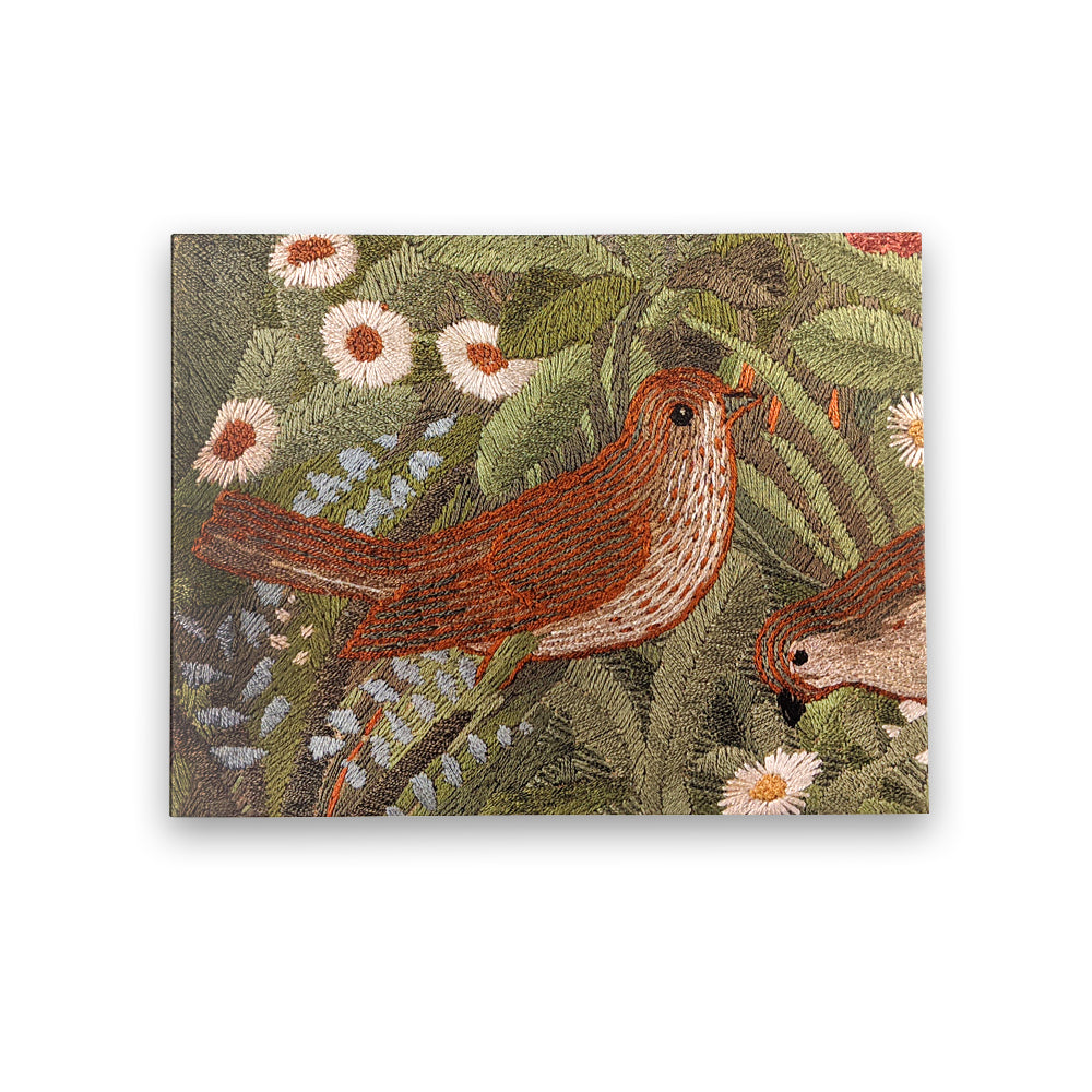 A horizontal rectangular greetings card with a detail from the 'Red Cross Knight' tapestry by Phoebe Anna Traquair. The detail is of a small brown bird surrounded by green leaves and white flowers.
