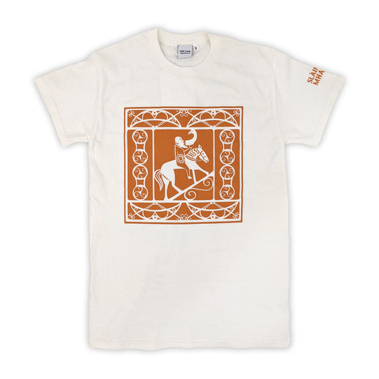 A white cotton tshirt with a square design taken from Pictish carvings of a man drinking whilst riding a horse surrounded by pattern work printed in orange.