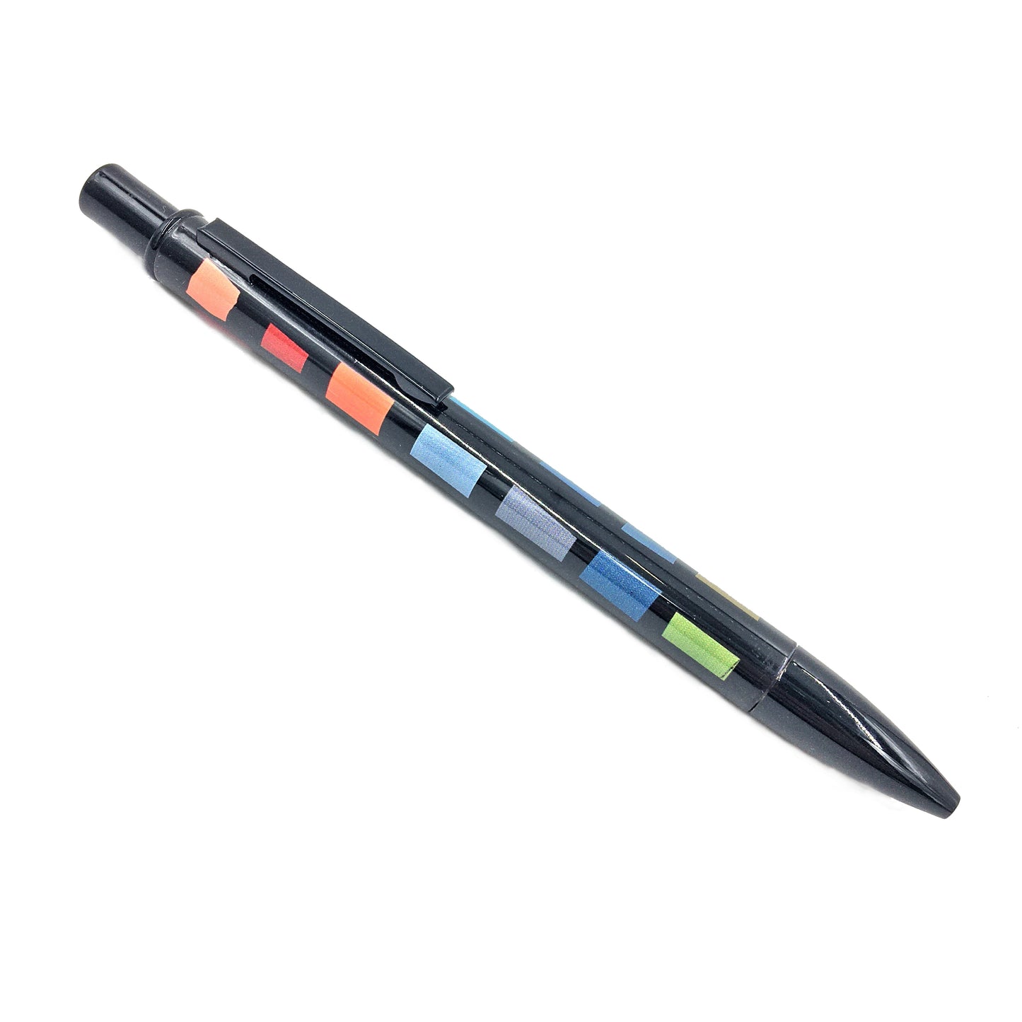 A black pen with Bernat Klein's colourful rectangular swatches along the body against a white background.