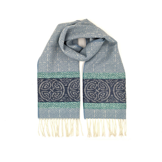 Pale blue tassled scarf with a celtic roundal pattern against a plain white background.