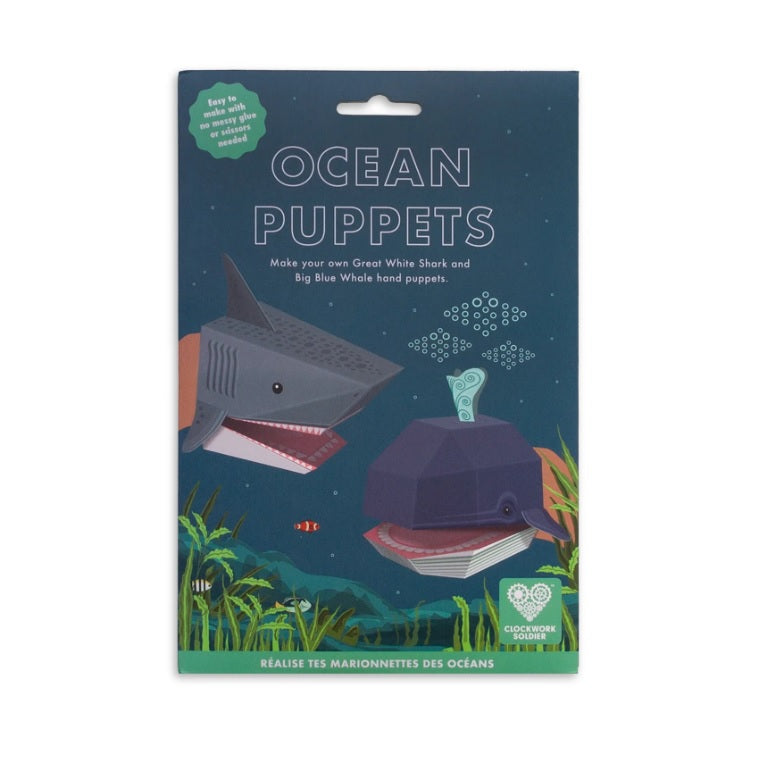 Packaging with a shark and a whale paper hand puppet among an ocean scene against a white background.