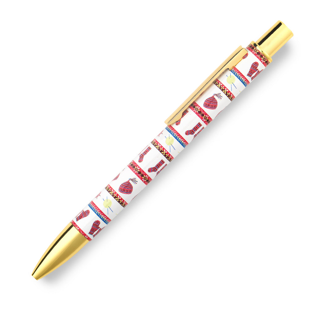 A metal ball point pen with a knitted fair isle inspired illustrated pattern against a plain white background.