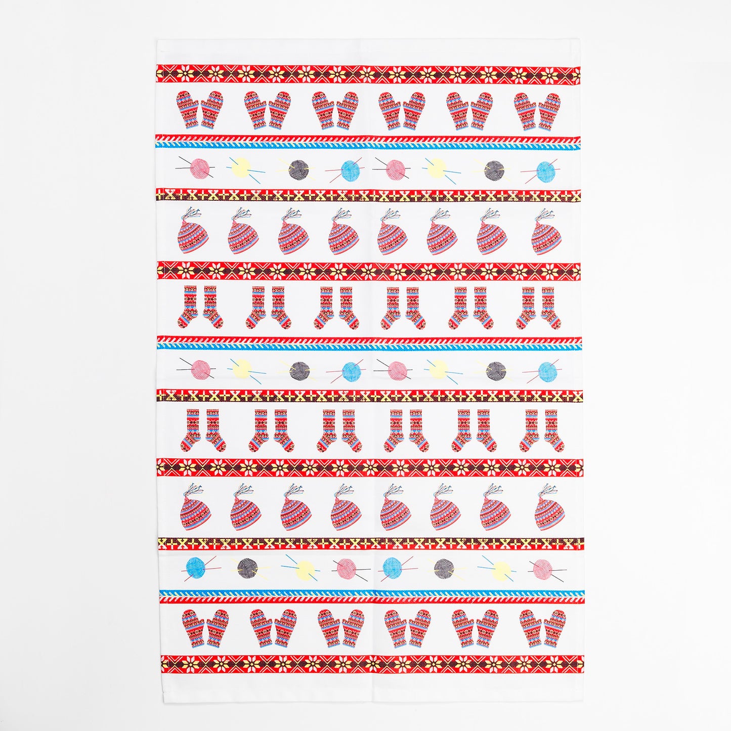 A cotton tea towel with a knitted fair isle inspired illustrated design against a plain white background.