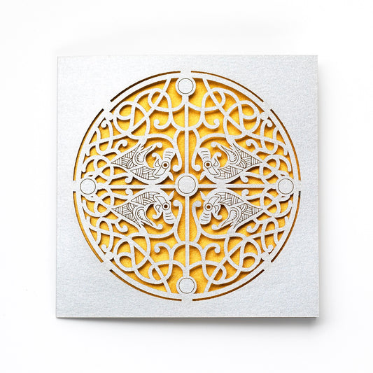 A greetings card with a cutout detail of a Galloway hoard brooch on silver card with gold card revealed underneath.