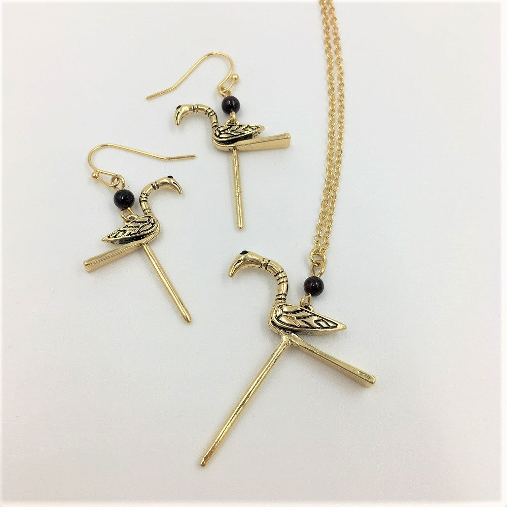 Two brass drop earrings and a necklace of small birds with craning necks, based on the gold pin found in the Galloway hoard.