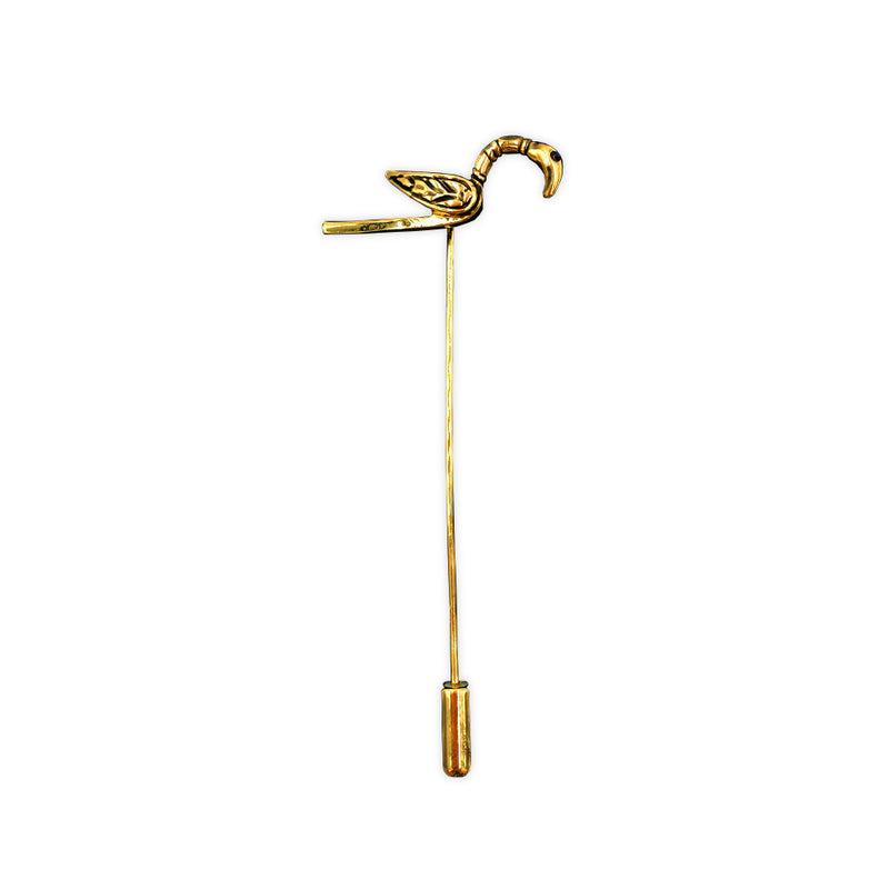 A brass clothes pin of a small bird with a craning neck, based on the gold pin found in the Galloway hoard.