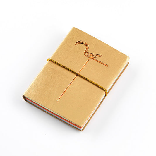 A small gold imitation leather bound notebook with a gold embossed design of a bird pin from the Galloway hoard, coloured pages and an elastic strap.