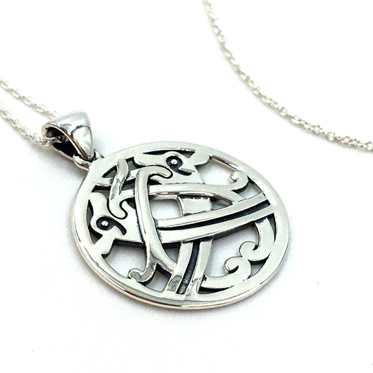 Round silver stud earrings and a silver pendant with an intertwined beast design taken from a detail of a brooch found in the Galloway hoard.