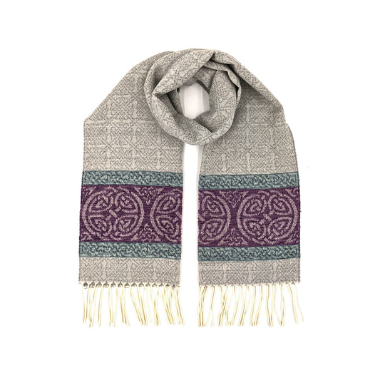 Grey tassled scarf with a purple celtic roundal pattern against a plain white background.