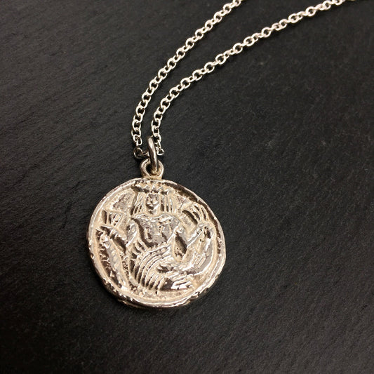 Sterling necklace with a pendant depicting an ivory game counter from the 15th or 16th century. The round counter has a mermaid wearing a crown and holding a larger fish by the tail in each hand.