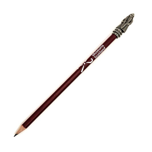 Maroon pencil with the National Museums Scotland logo printed in white. The pencil is topped with a metal Lewis chess piece berserker.
