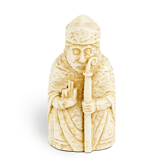 A resin replica of a bishop Lewis chess piece. The bishop is wearing long robes and his right hand is raised and he is holding a long crook in his left.