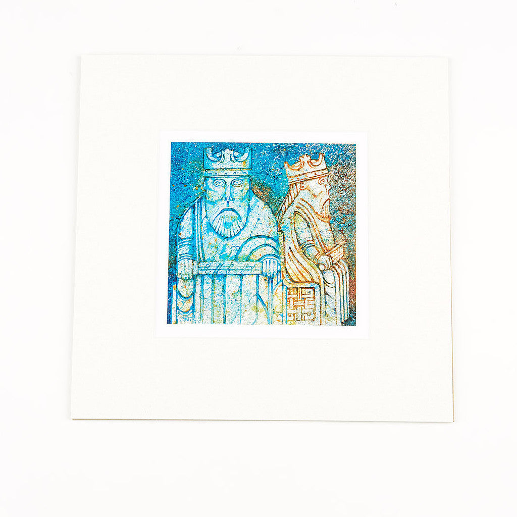 A square mounted print of a stylised painting of a king Lewis chess piece. It is painted in blues and yellows.