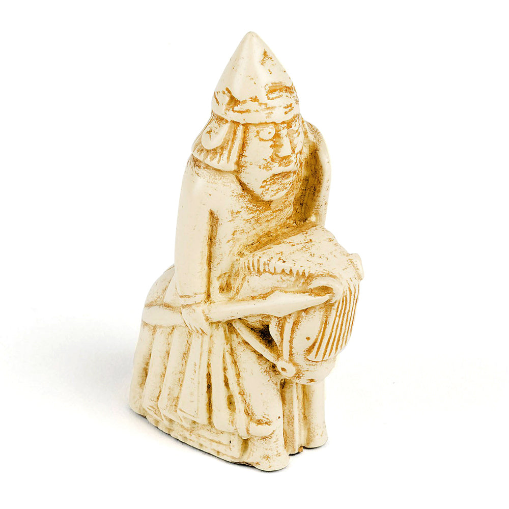 A resin replica of a knight Lewis chess piece. The knight is wearing a pointed helmet and is riding a horse. In his right hand he is holding a spear and a shield in his left hand.