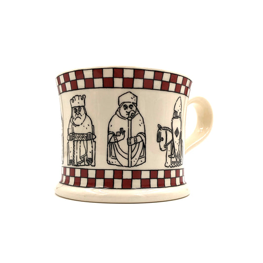 A round ceramic mug with line illustrations of the Lewis chess pieces. There is a red chess board pattern along the whole of the top and bottom outer edge. The words "The Lewis Chessmen" is along the inside of the upper edge.