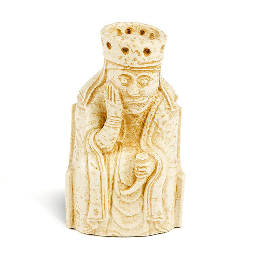 A resin replica of a queen Lewis chess piece. The queen is wearing long robes and a crown, and is sitting on a throne decorated with knot work. She has her chin resting in her right hand and is holding a drinking horn in her left.