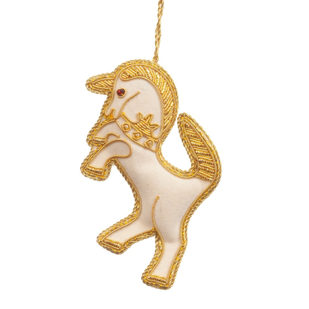 An embroidered hanging decoration of a Scottish unicorn. The decoration is made from white fabric and is embroidered with gold thread