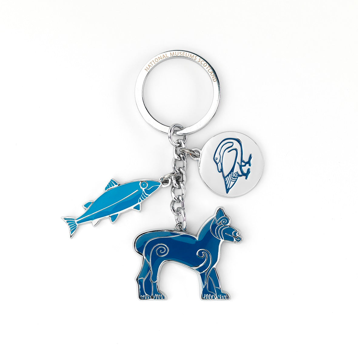 A photograph of a silver key ring with three charms of animals taken from Pictish folk art. On the left is a charm of a fish in light blue with silver detailing, in the centre is a lion in a navy blue with silver detailing, and on the right is a silver disk with a goose embossed in navy blue.