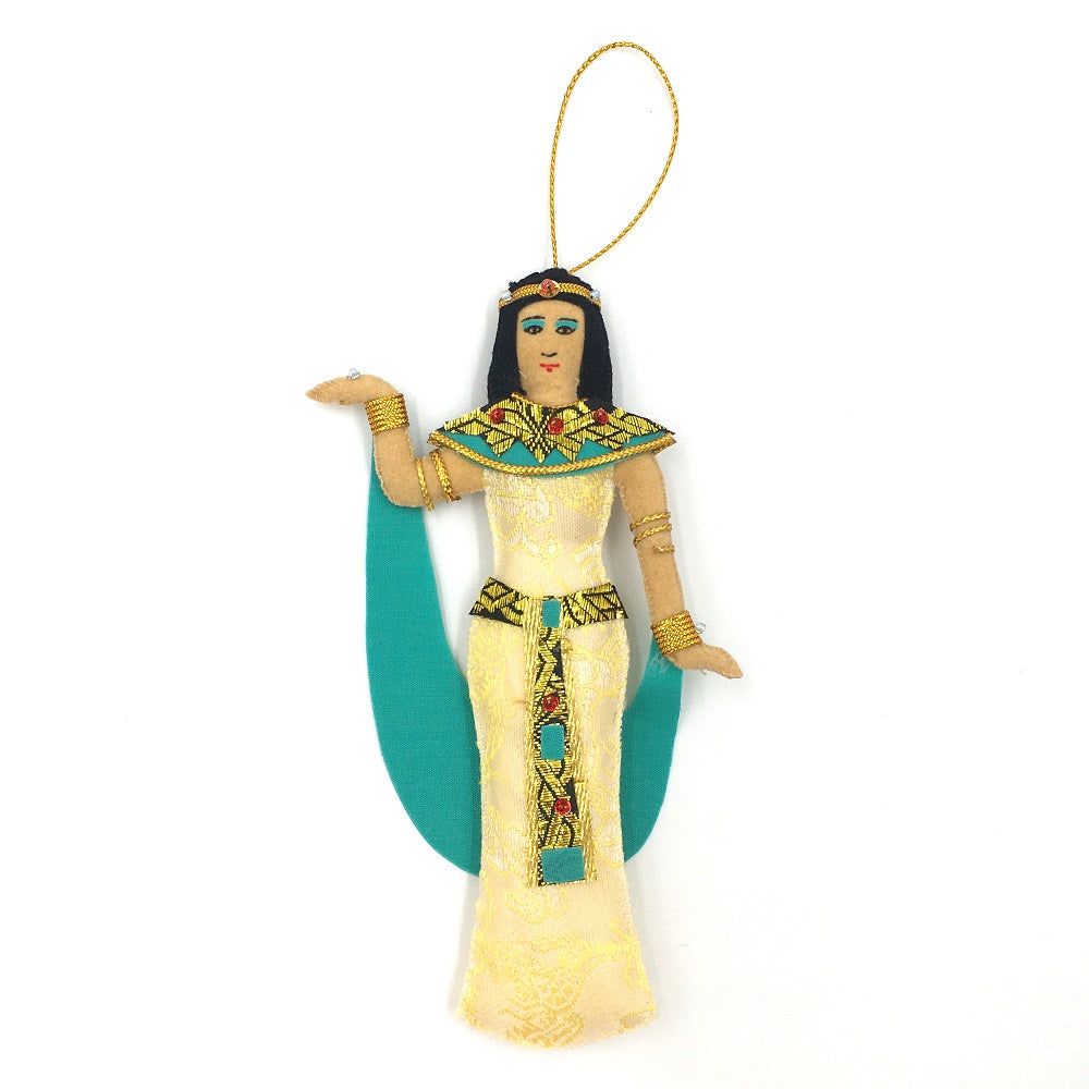 An embroidered decoration of Cleopatra. The decoration depicts Cleopatra dressed in traditional ancient Egyptian clothes with blue and gold detailing.