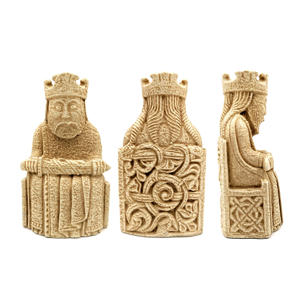A front, side, and reverse view of a Lewis chessmen king resin replica bookend. The king sits in a throne decorated with knot work and wears a crown and long robes, he is holding a sword across his knee.