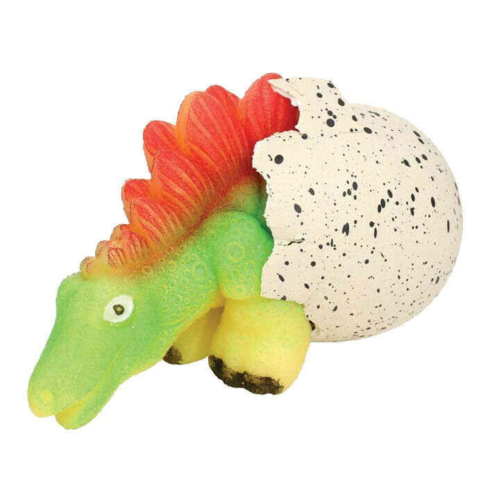 A small green and yellow dinosaur hatching out of an egg with black speckles.