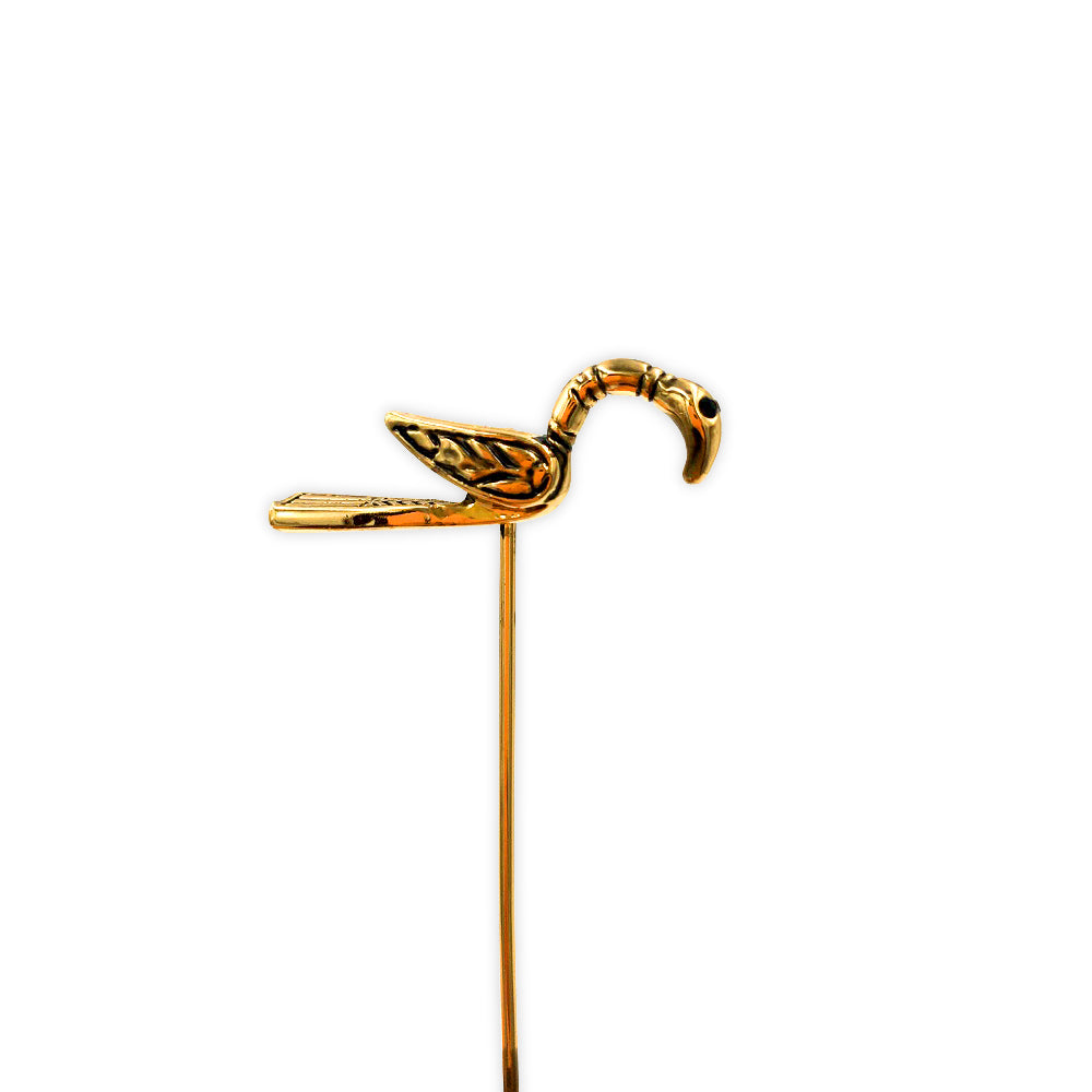 A brass clothes pin of a small bird with a craning neck, based on the gold pin found in the Galloway hoard.
